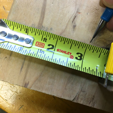 Measuring to cut a piece of wood